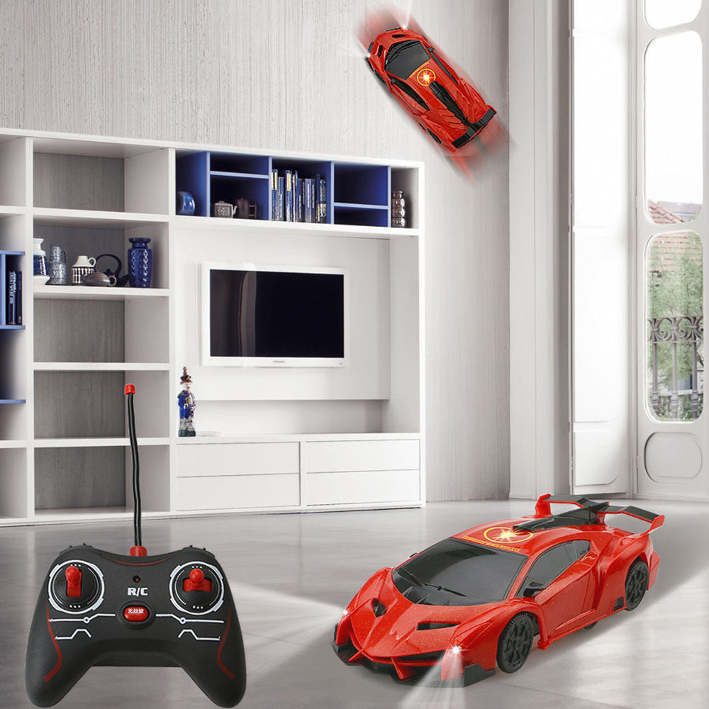 Remote Control Wall-Climbing Car - red car on a wall and floor beside black controller
