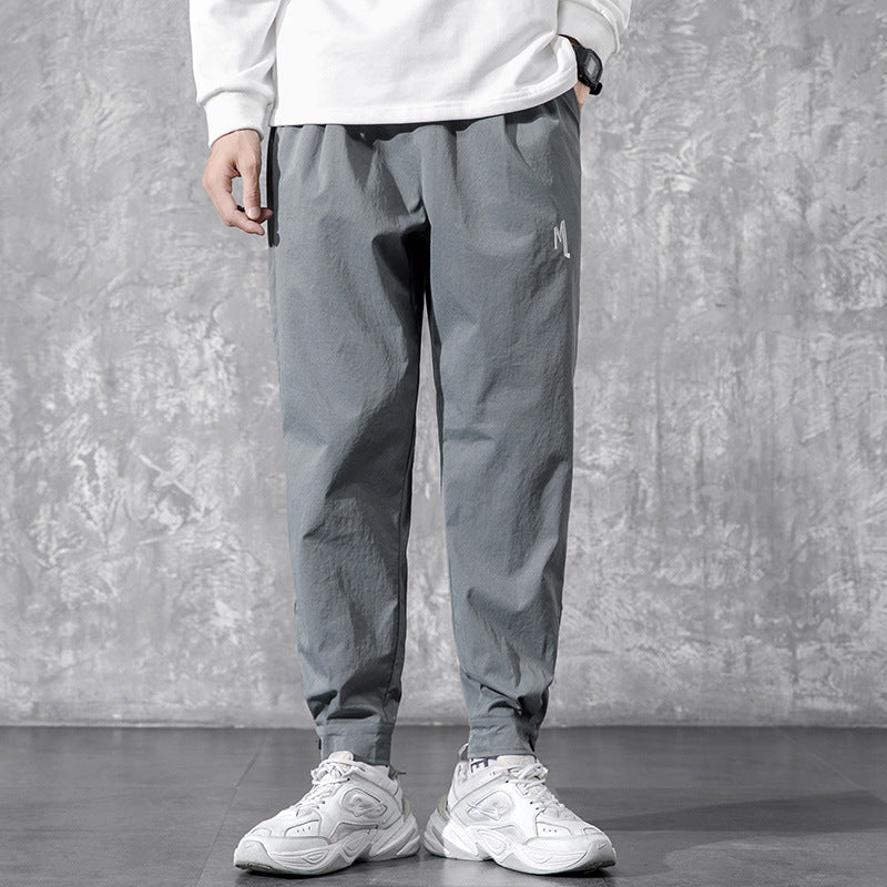 Men's Utility Cargo Pants - model wearing gray tapered pants with white sneakers