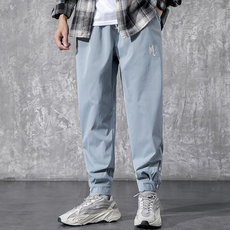 Men's Utility Cargo Pants - model wearing blue-gray pants with buttoned ankle cuffs