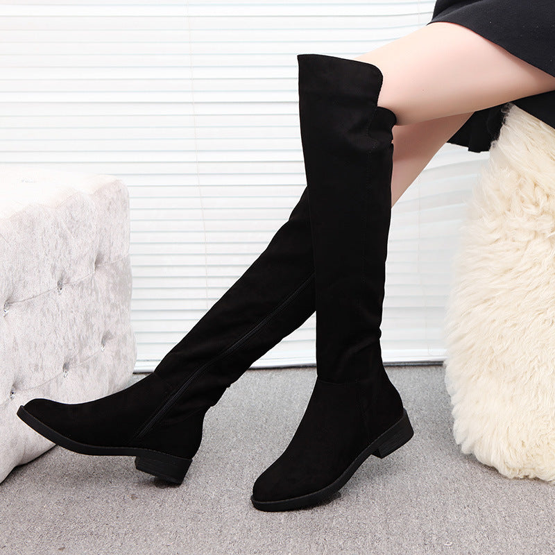 Women's Over-the-Knee Flat Boots - black boots with low block heels worn by a seated model