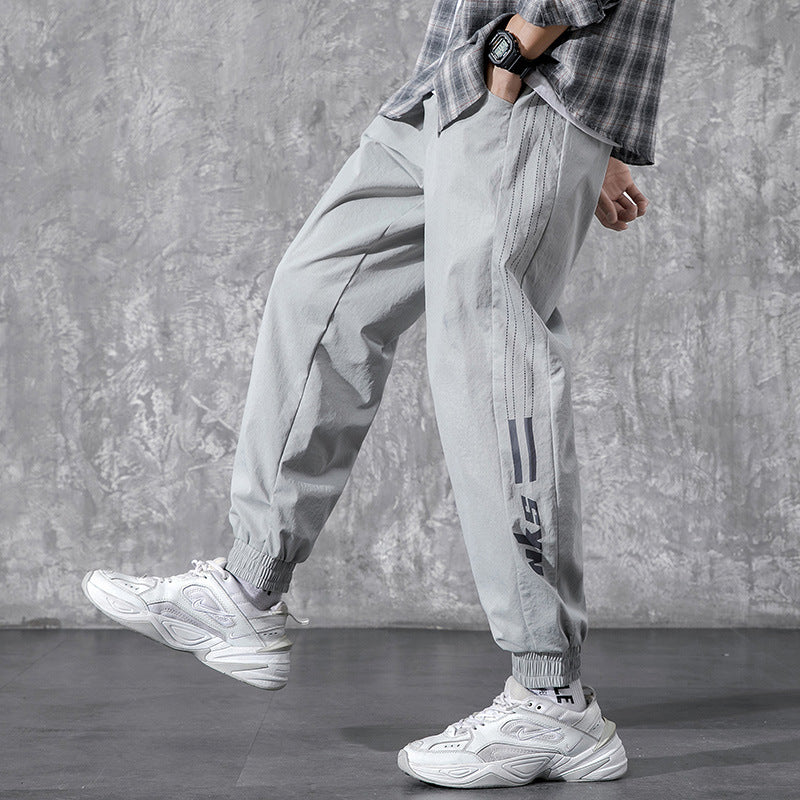 Men's Utility Cargo Pants - side view of light gray pants with printed leg stripes and gathered cuffs